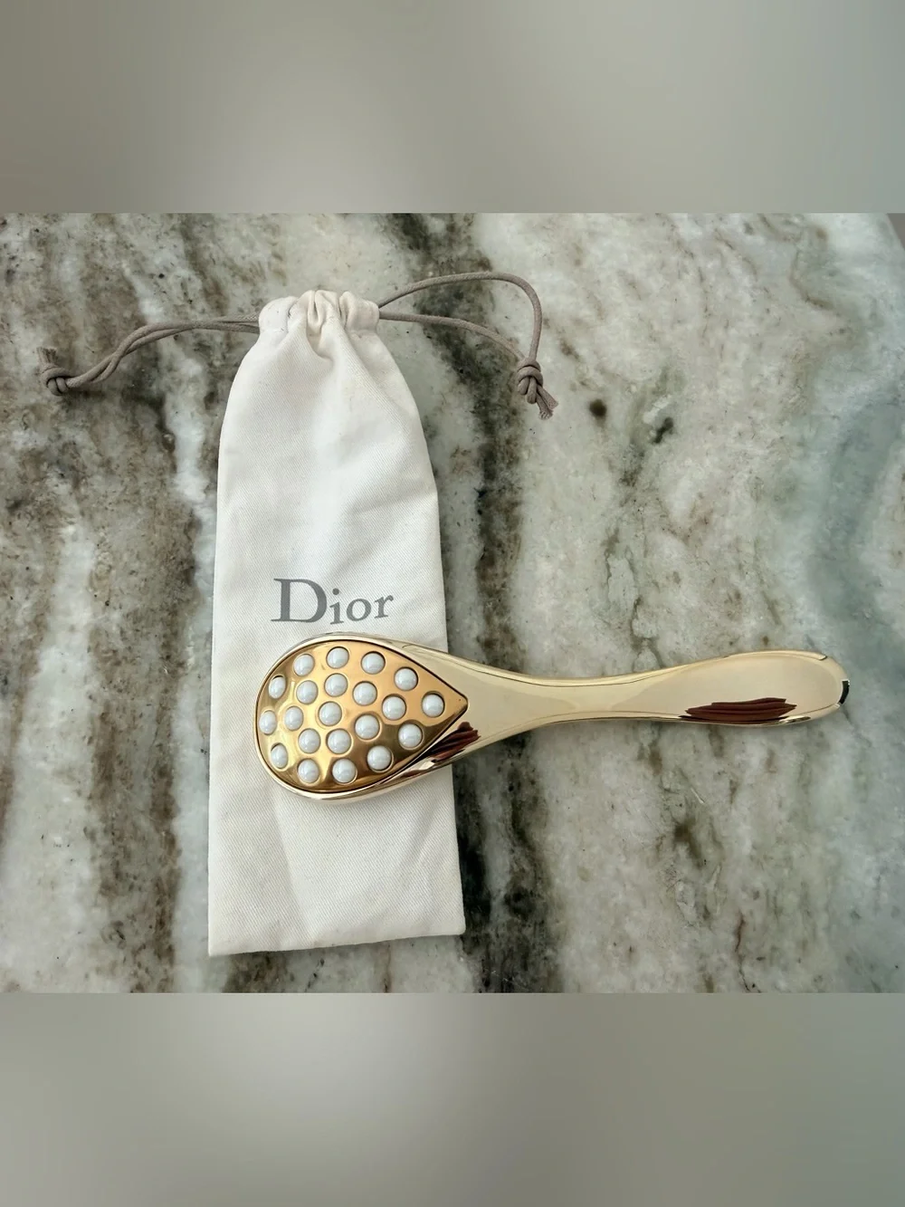 Dior Prestige Le Pétale Multi-Perlé Massage Tool with a branded protective pouch